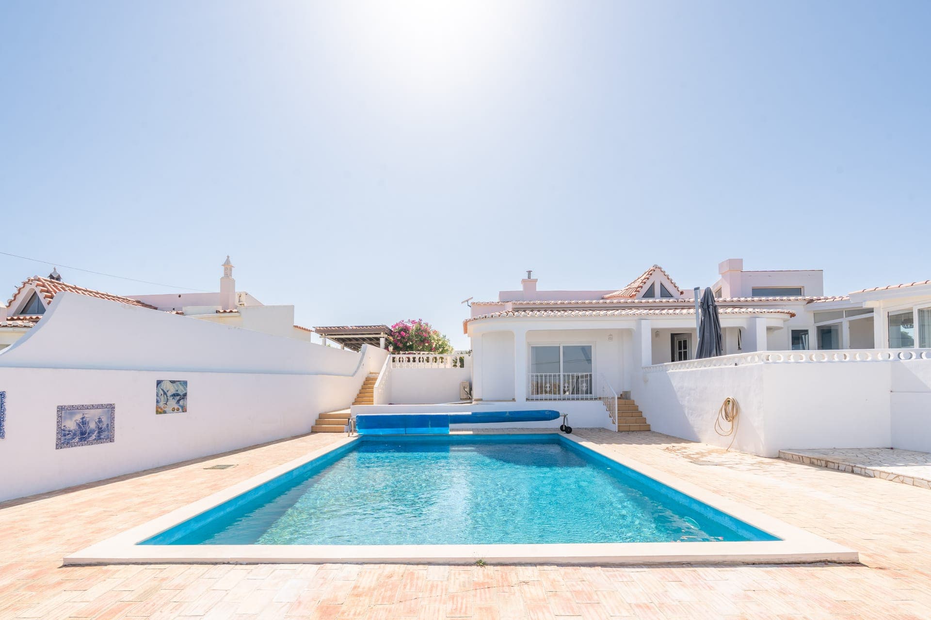 Front view of Casa dos Amigos, a whitewashed villa in Budens with its garden and private pool
